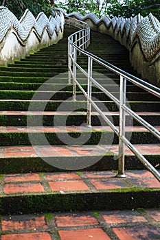 Safety Handrail help climbing up Two Naga Guardians stairway uphill to Wat Phra That Doi Tung temple, Chiang Rai, Thailand. Thai T