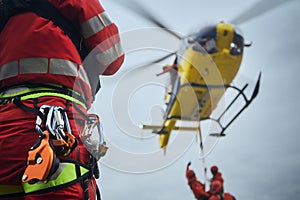 Safety harness of paramedic of emergency service in front of helicopter