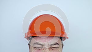 Safety helmet. Brick and a board fall on builder head. Saving a life due to wearing a protective construction helmet. Protection o