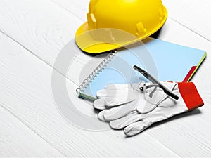 Safety helmet with gloves and notebook on