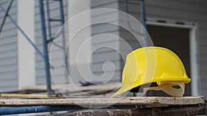 Safety helmet hard hat for engineer, safety officer, or architect, place on cement floor. Yellow safety hat helmet in