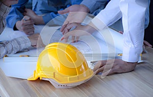 Safety helmet placed on a meeting table engineering team. ,Engineering concept.