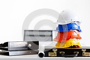 Safety helmet on table in office , engineer concept Teamwork of