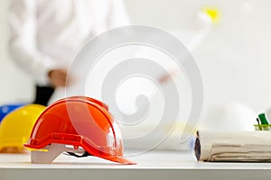 Safety helmet on table in office , engineer concept Teamwork of