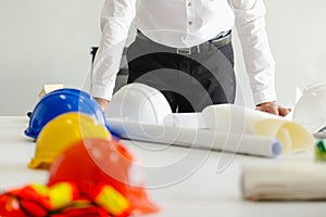 Safety helmet on table in office , engineer concept Teamwork of