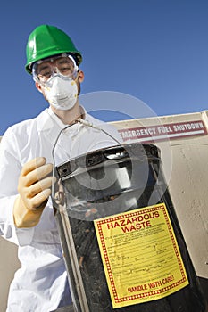 Safety inspector holding hazardous waste