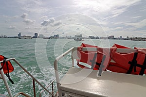 Safety life jacket on ferry boat sailing in sea.