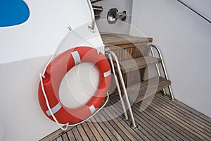 Safety life ring and steps on deck of a yacht