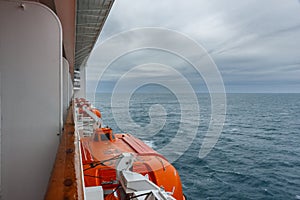 Safety lifeboat on deck of a cruise ship. Bad weather condition.