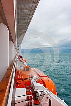 Safety lifeboat on deck of a cruise ship. Bad weather condition.