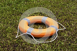 Safety lifesaver on a green grass background