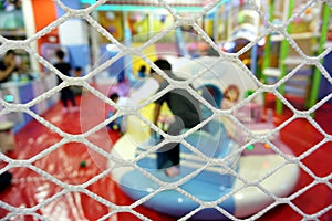 Safety mesh for children at indoor playground with blurred focus