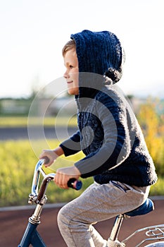 Safety in a modern European city. little happy boy rides a bike on a secure rubberized bike path