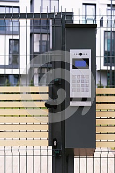 Safety in modern residential buildings. fenced yard, closed gate with electronic lock.
