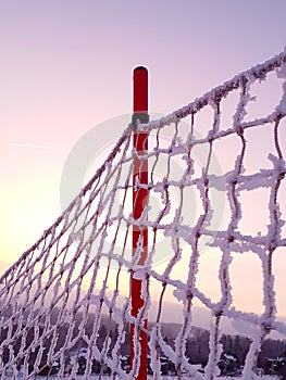 Safety net on red stick on sunset background