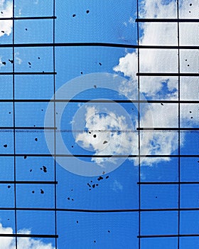 Safety net to catch rocks against blue sky with clouds