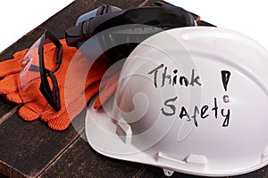 Safety personal protective euipment on a black wooden table on a white background