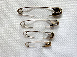 Safety pin on fabric background