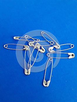 Safety pins on a blue background