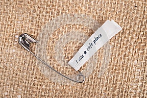 Safety pins on clothes with label