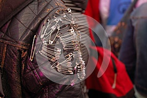 Safety pins on leather jacket