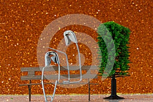 Safety pins on a small bench with a red glitter background