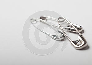 Safety pins on a white background