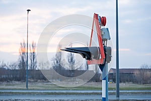 Safety railroad or railway traffic light sign for trains where rails cross over with road for cars and vehicles side view selectiv