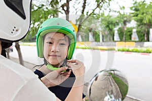 Safety riding concept.Mother trying to wear a bike helmet to his