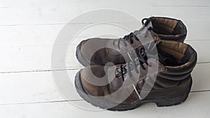 Safety shoes on a white wooden floor
