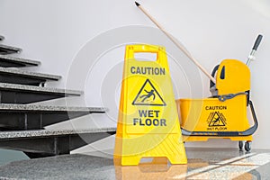 Safety sign with phrase Caution wet floor