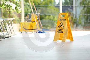 Safety sign with phrase Caution wet floor