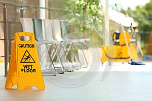 Safety sign with phrase Caution wet floor