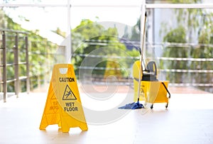 Safety sign with phrase Caution wet floor