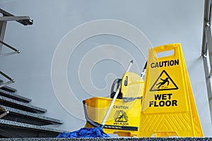 Safety sign with phrase Caution wet floor