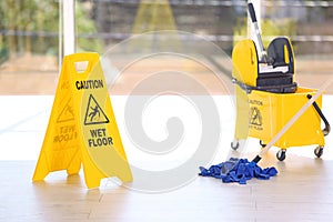 Safety sign with phrase Caution wet floor