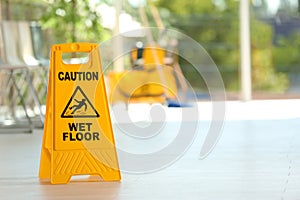 Safety sign with phrase Caution wet floor