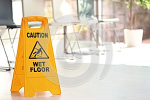 Safety sign with phrase Caution wet floor, indoor