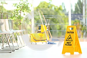 Safety sign with phrase Caution wet floor