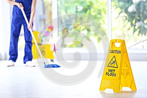 Safety sign with phrase Caution wet floor
