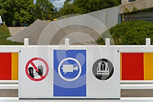 Safety signs on a construction barrier in a work site