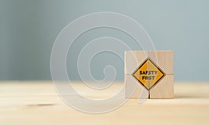 Safety symbols and first signs, work safety, caution work hazards, danger surveillance, zero accident concept on wooden cubes with