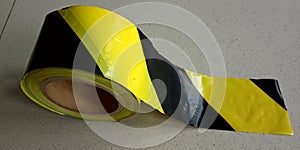 a safety tape against a floor backdrop