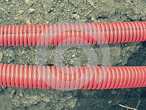 Safety tube with cables. Reconstruction site with trench