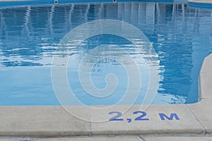 safety on water concept, close up image of signs of depth in meters in swimming pool,