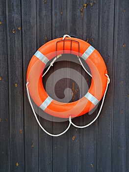 Lifering hanging on dark black wooden wall