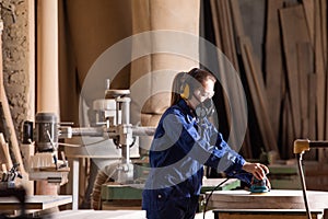 Safety in woodworking. Female carpenter in googles and dust mask