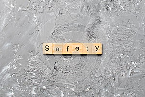 Safety word written on wood block. safety text on cement table for your desing, concept