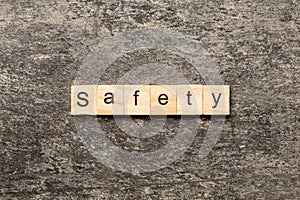 safety word written on wood block. safety text on cement table for your desing, concept