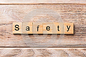 Safety word written on wood block. safety text on wooden table for your desing, concept